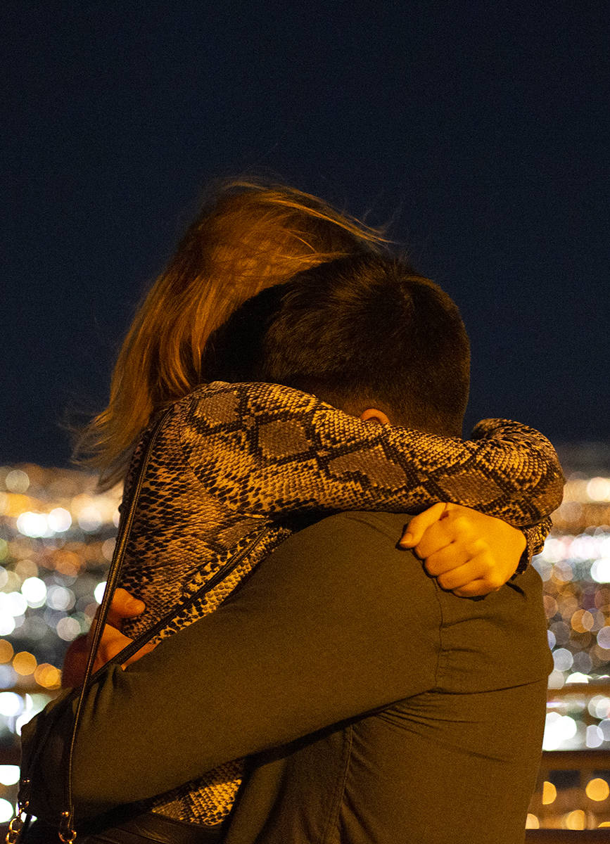 A couple embraces as 2020 becomes 2021 on New Year's Eve on the observation deck of at The STRA ...