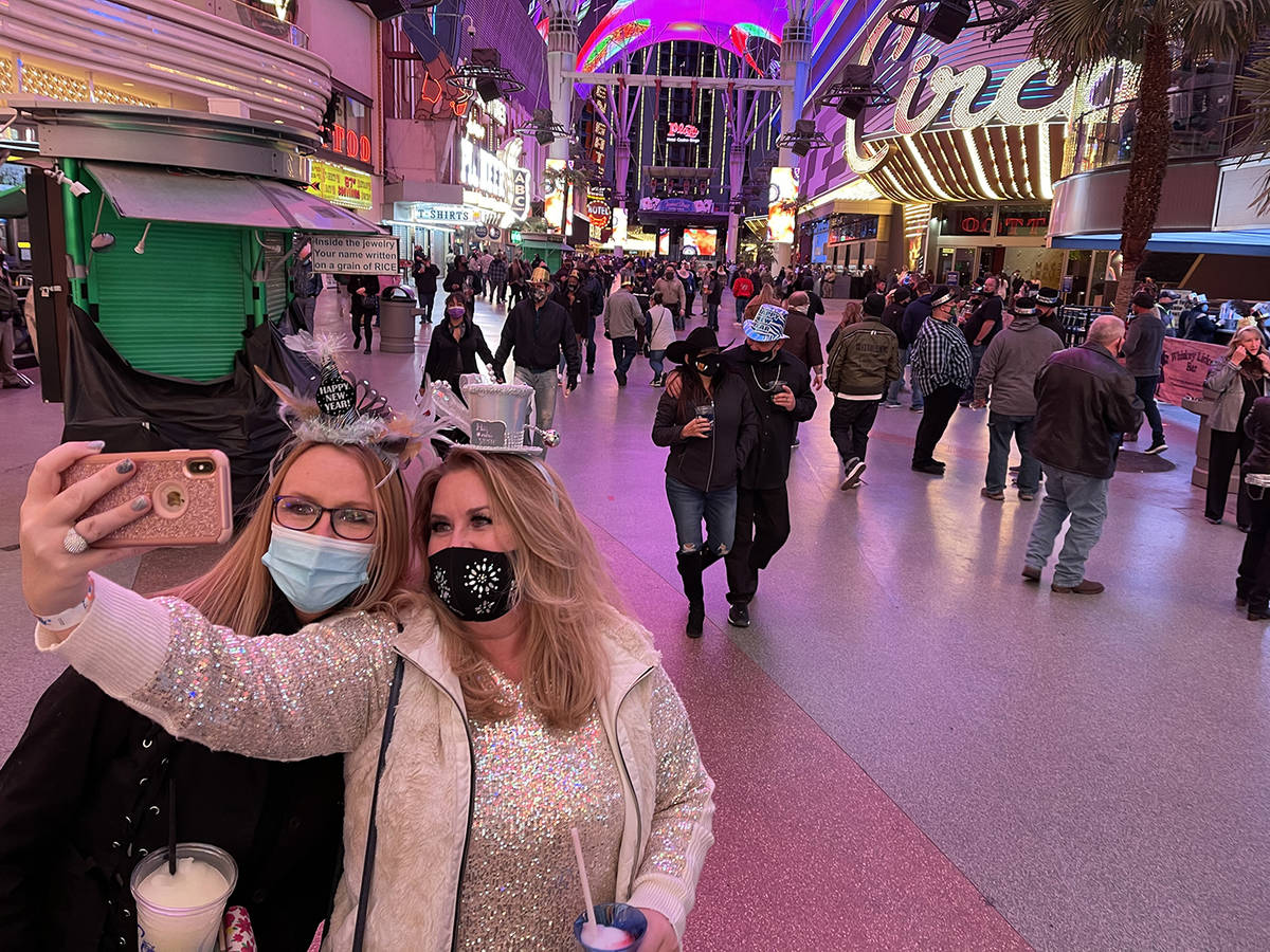 Sisters Christine, left , and Rebecca Loffert celebrate New Year's Eve at the Fremont Street Ex ...