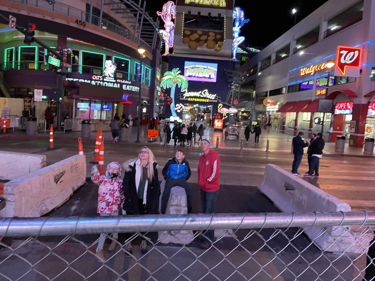 People wait on Fourth Street to watch the Fremont Street Experience light show on New Year's Ev ...
