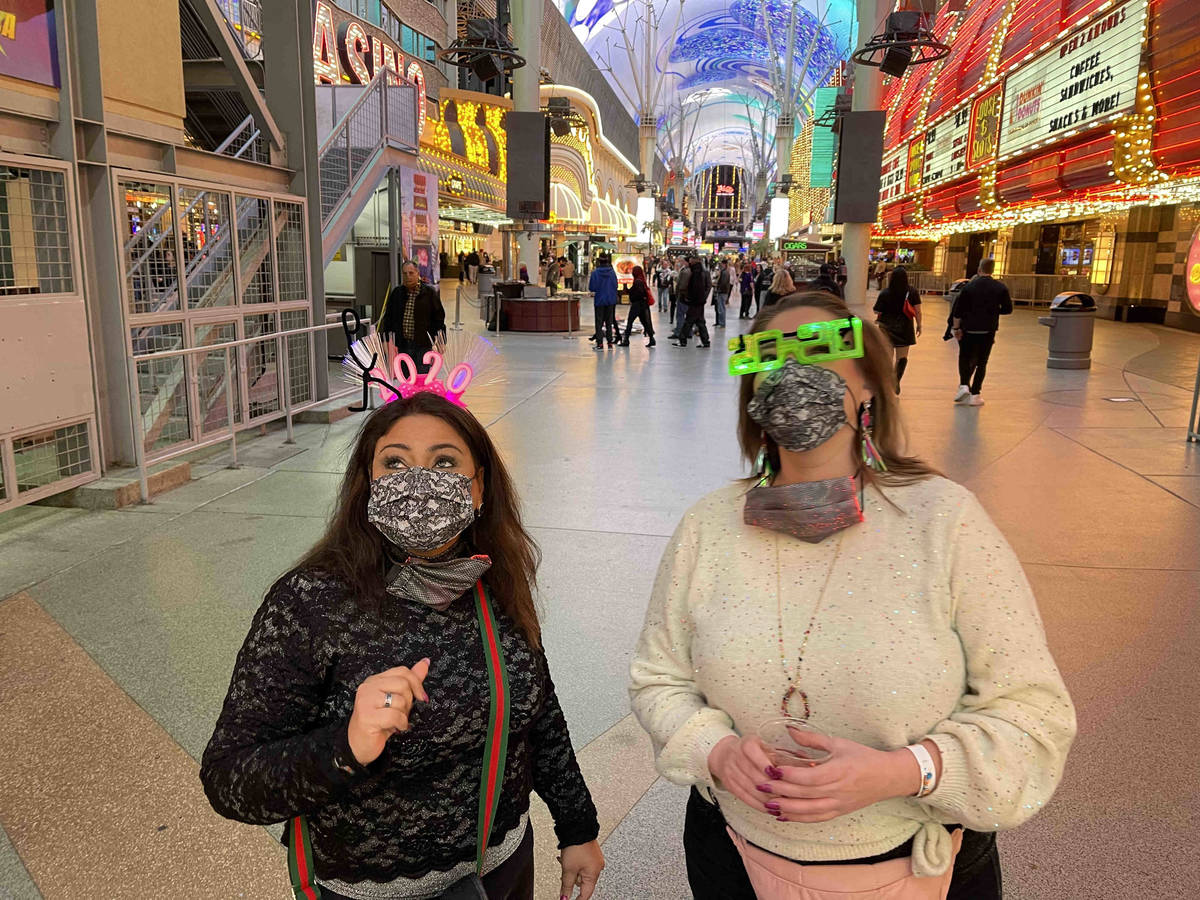 Erum Shahzad, left, and Natalie Melton, both of Dallas, celebrate New Year's Eve at the Fremont ...