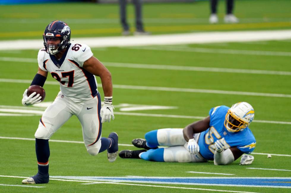 Denver Broncos tight end Noah Fant (87) runs after a catch during the second half of an NFL foo ...