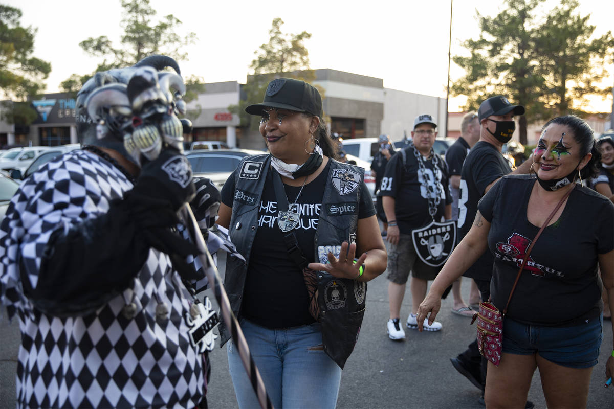 Raider Jester, left, whose name is Anthony Herrera, is shown at a Raiders party in Las Vegas on ...