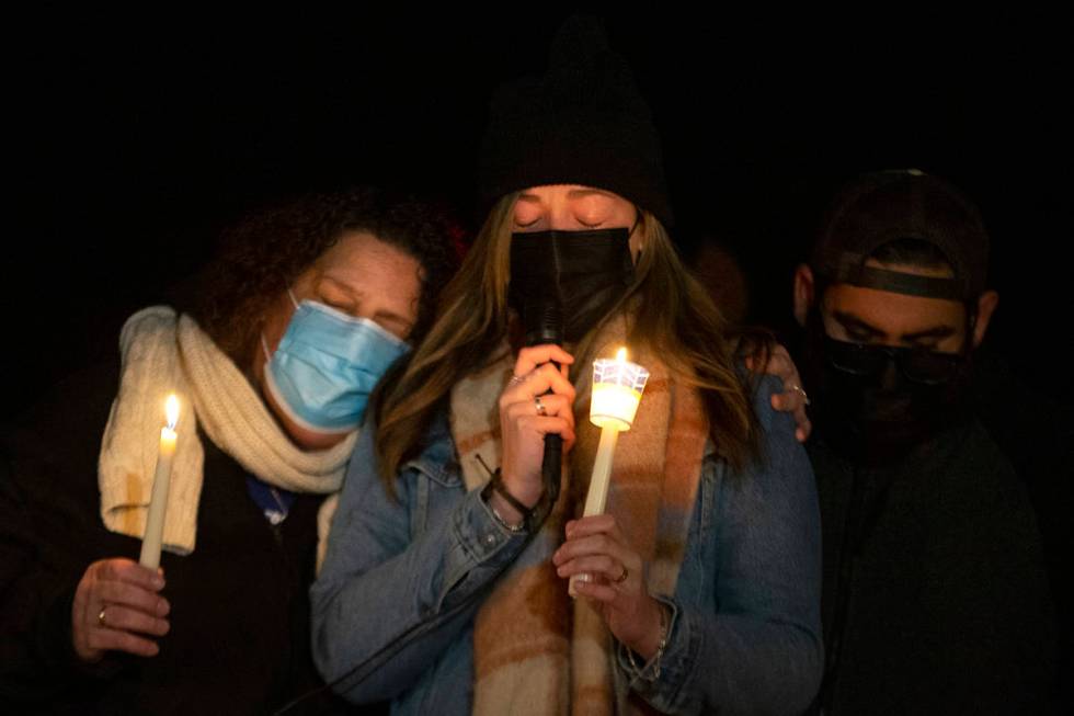 Annmarie Echevarria, left, and Ashley Robledo, center, wife and stepdaughter of Eric Echevarria ...