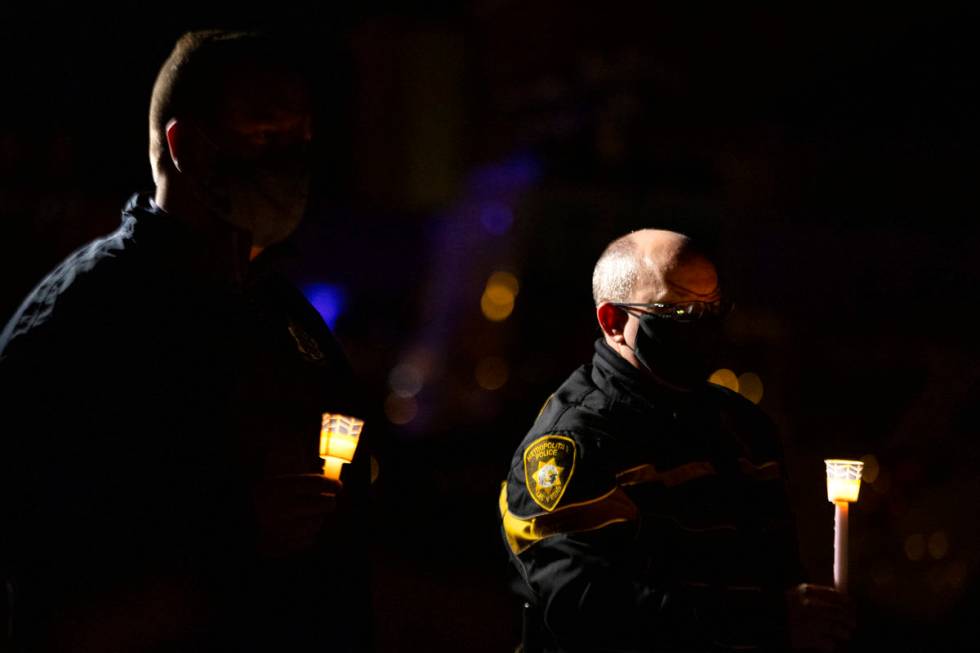 Metropolitan police Traffic Lt. Brett Ficklin, right, attends a vigil for Eric Echevarria, a 52 ...