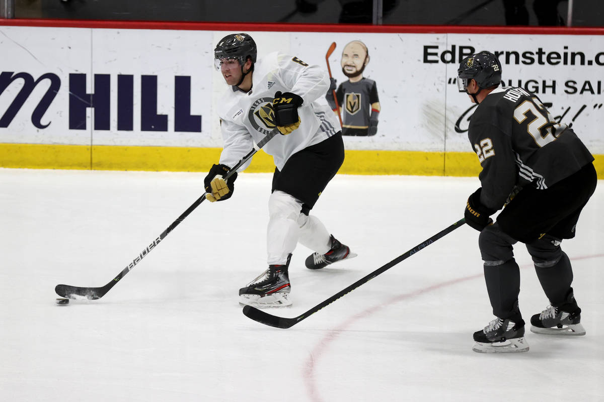 Golden Knights forward Jack Dugan (8) and defenseman Alec Martinez (22) during a scrimmage on t ...