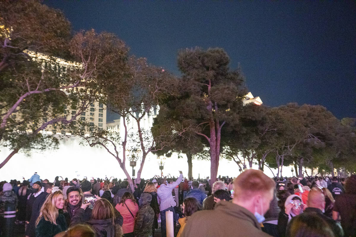 Individuals gather to celebrate New Year's Eve on the Las Vegas Strip, Thursday, Dec. 31, 2020. ...