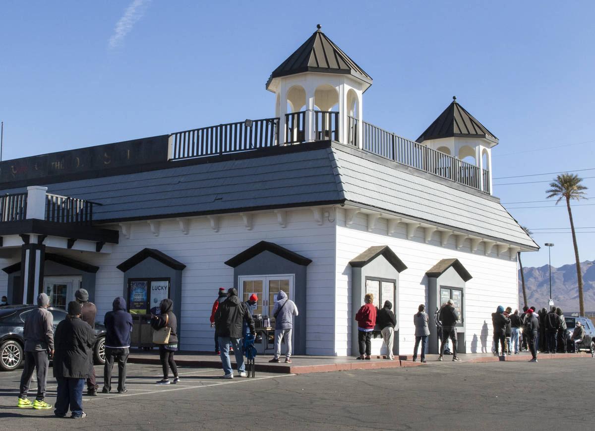 Hundreds line up outside of The Lotto Store at Primm as people wait to buy Mega Million and Pow ...