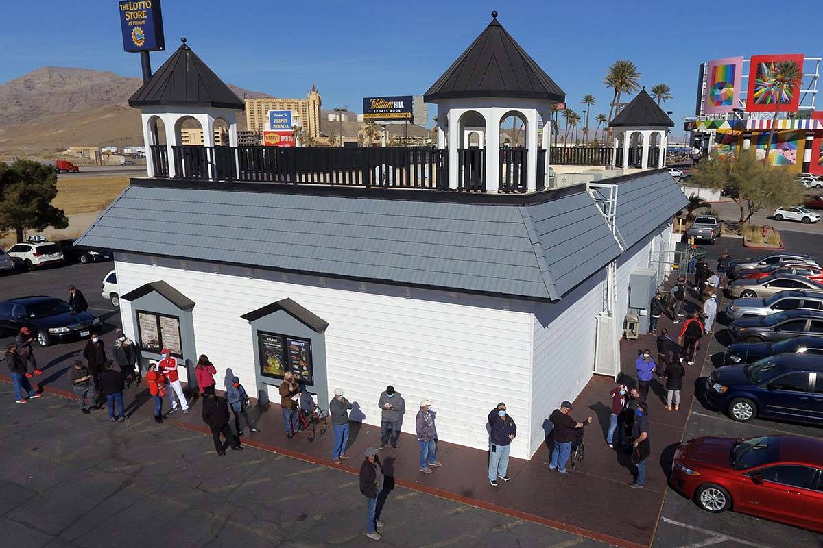 Hundreds line up outside of The Lotto Store at Primm as people wait to buy Mega Millions and Po ...