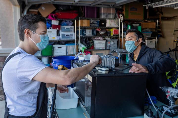 UNLV graduates Scott Isler, 33, left, and Jeffrey Topacio, 32, work on their project, "Mic ...