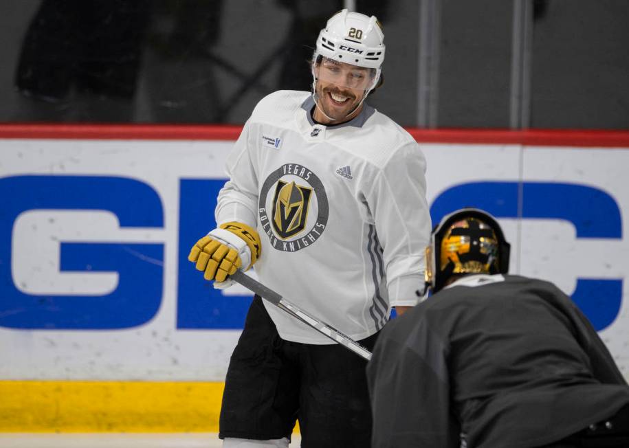 Golden Knights forward Chandler Stephenson (20) jokes around with Golden Knights goaltender Mar ...