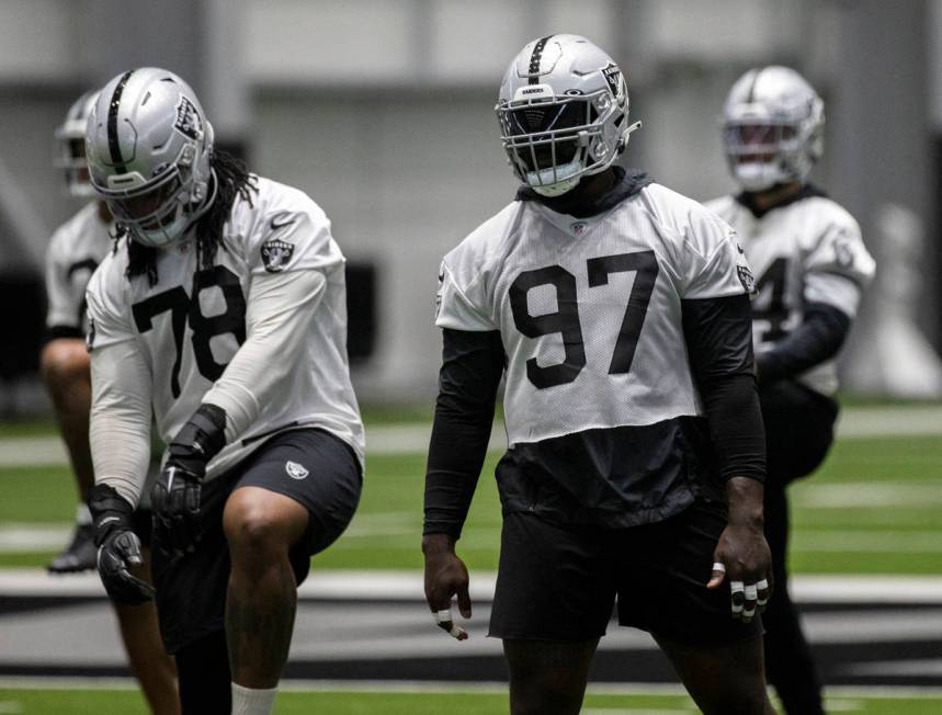 Raiders defensive tackle Maliek Collins (97) stretches during NFL football training camp practi ...