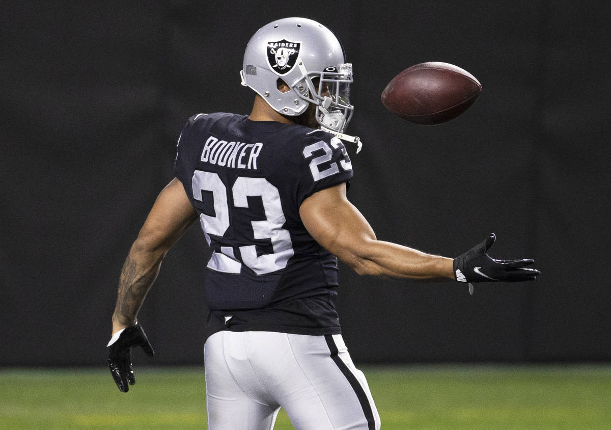 Raiders running back Devontae Booker (23) warms up before the start of an NFL football game aga ...