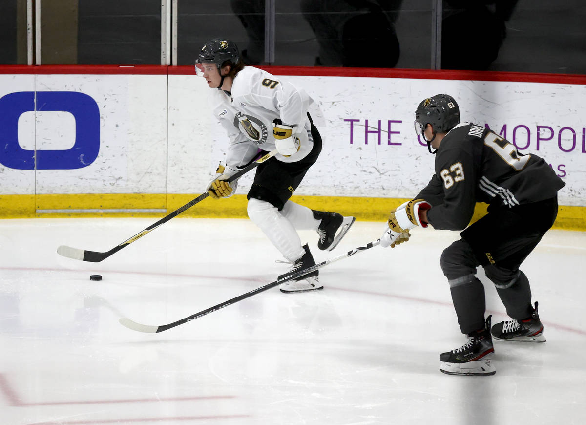 Golden Knights center Cody Glass (9) moves the puck past defenseman Carl Dahlstrom (63) during ...
