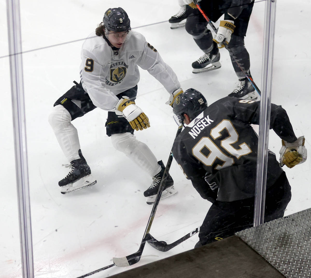 Golden Knights center Cody Glass (9) battles for the puck with center Tomas Nosek (92) during t ...