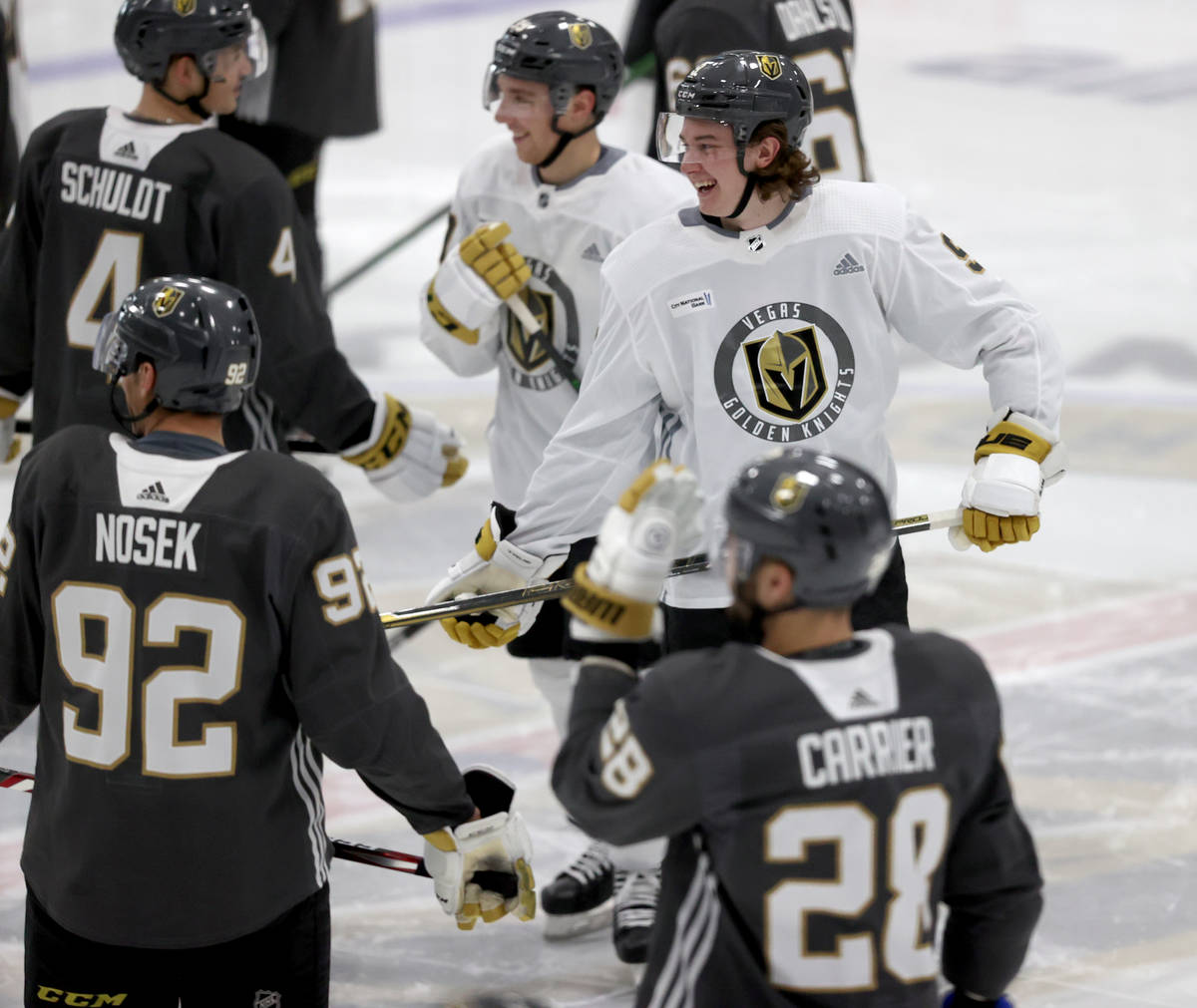 Golden Knights center Cody Glass (9) shares a laugh with teammates during training camp at City ...