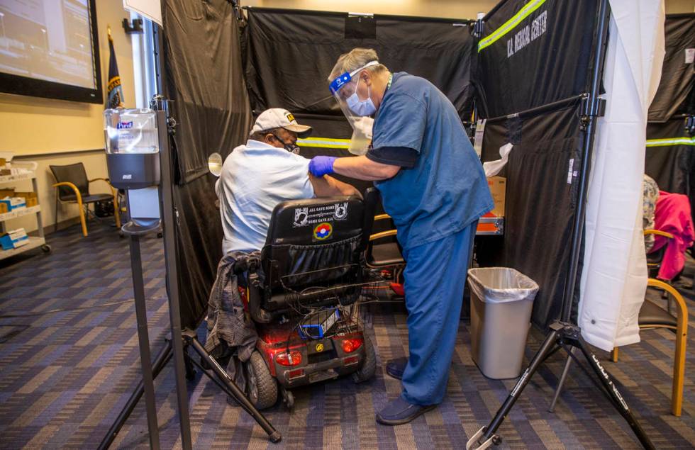 Veteran Levi Williams, left, is patched up after receiving a shot from RN Darrel Cowlishaw as s ...