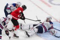Canada's Peyton Krebs (18) is stopped by United States goalie Spencer Knight (30) during the th ...