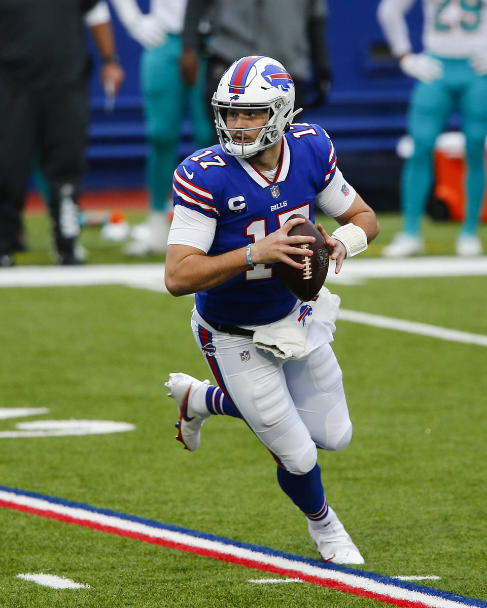 Buffalo Bills quarterback Josh Allen (17) looks to pass on the run in the first half of an NFL ...
