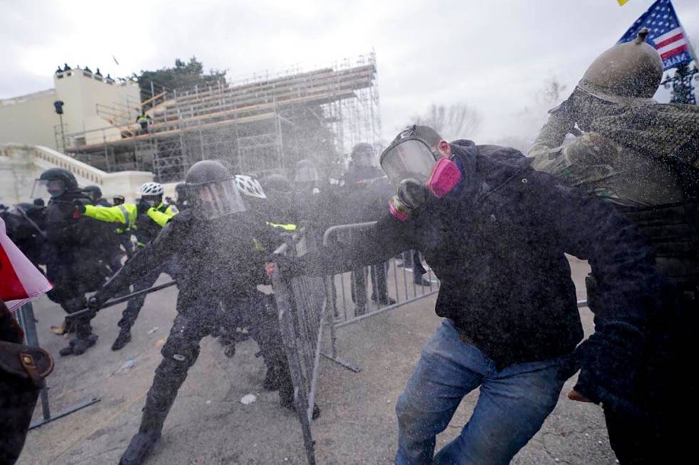 Trump supporters try to break through a police barrier, Wednesday, Jan. 6, 2021, at the Capitol ...