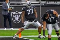 Raiders offensive tackle Trent Brown (77) stretches before an NFL football game against the Ind ...