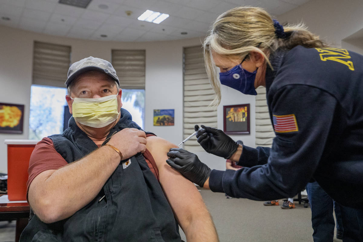 North Las Vegas Fire Department operations Battalion Chief Scott Morris, left, is administrated ...