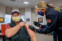 North Las Vegas Fire Department operations Battalion Chief Scott Morris, left, is administrated ...