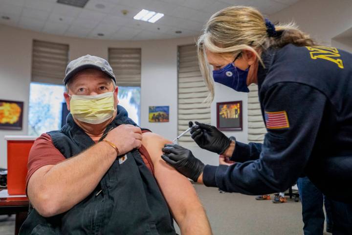 North Las Vegas Fire Department operations Battalion Chief Scott Morris, left, is administrated ...