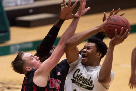Colorado State forward Dischon Thomas, right, tries for a shot as UNLV forward Moses Wood defen ...