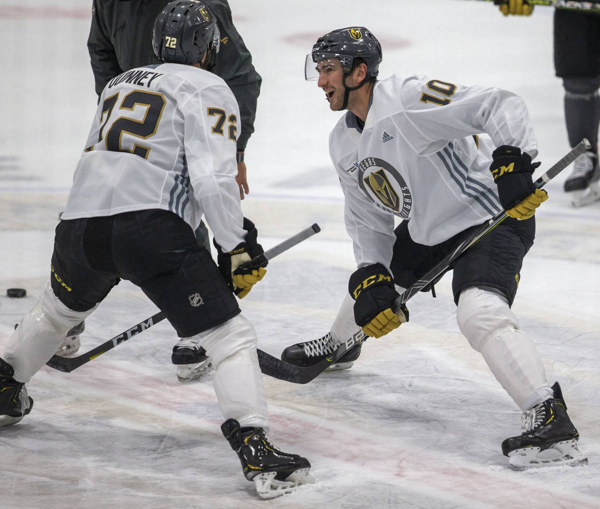 Golden Knights left wing Gage Quinney (72) and Golden Knights center Nicolas Roy (10) engage in ...