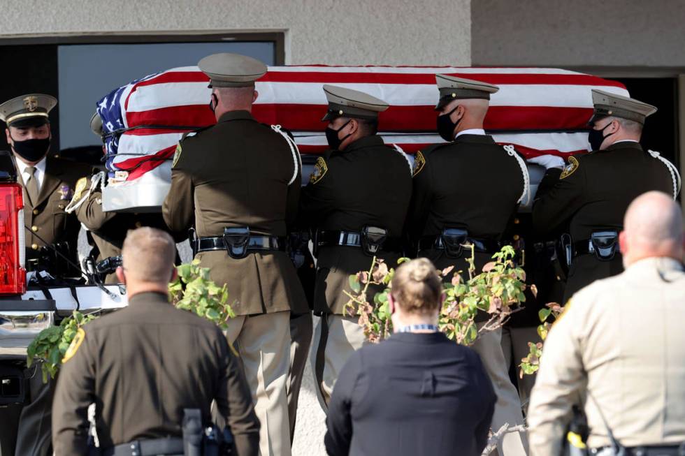 Honor guard members load the casket of Metropolitan Police Department Lt. Erik Lloyd at Palm Do ...