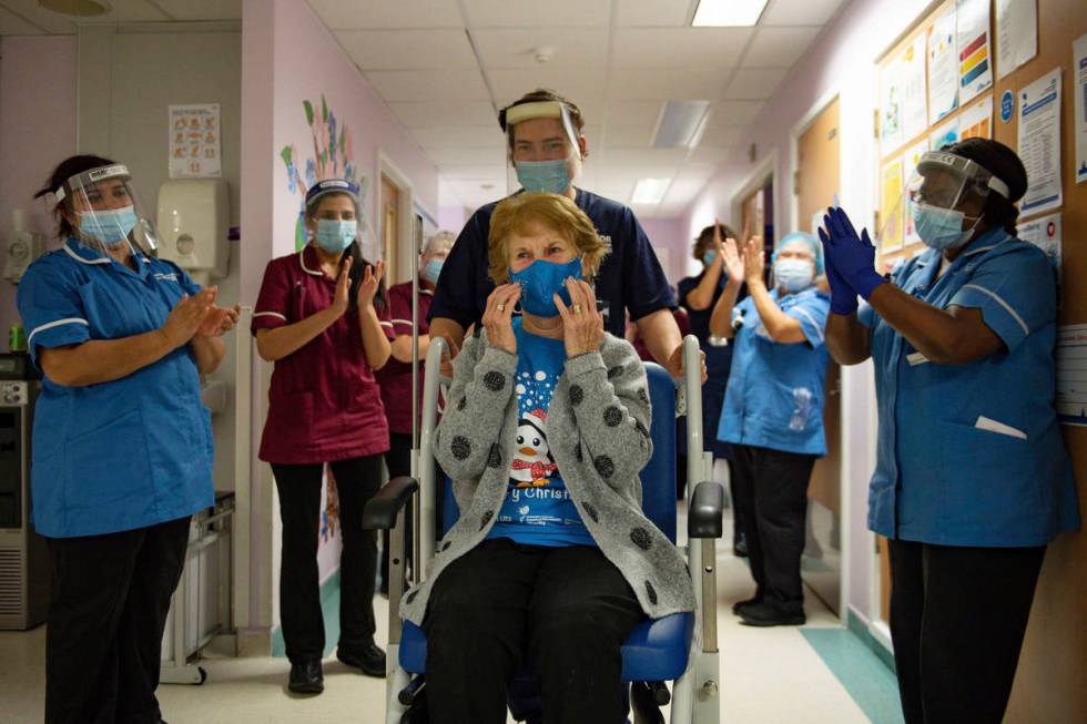 Margaret Keenan, 90, is applauded by staff as she returns to her ward after becoming the first ...