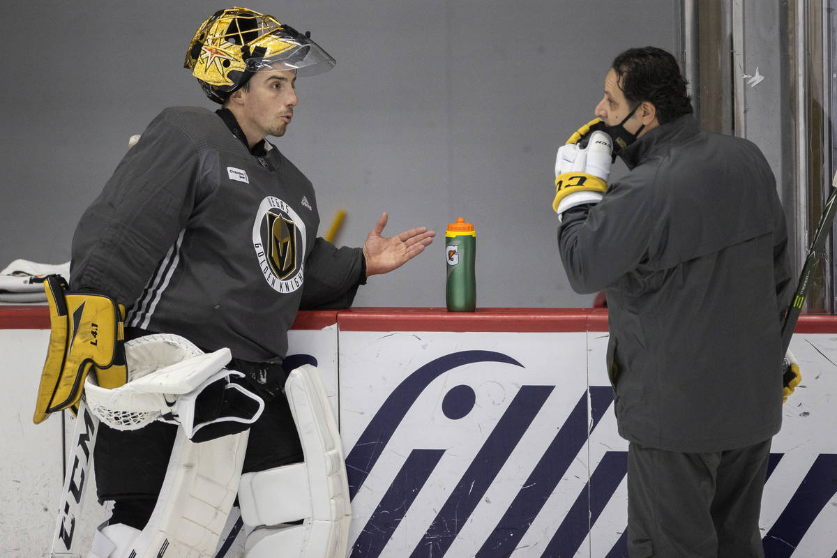 Golden Knights goaltender Marc-Andre Fleury (29) talks with goalie coach Mike Rosario during pr ...