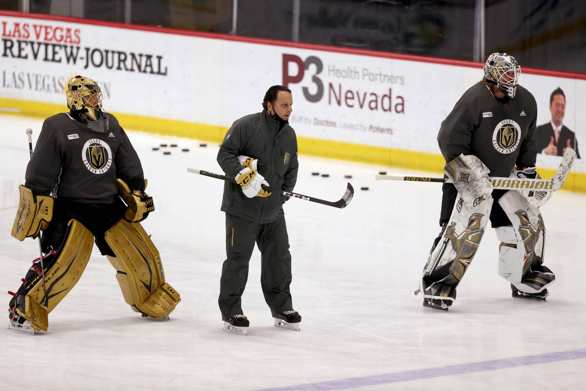 Golden Knights goaltenders Marc-Andre Fleury (29), left, Robin Lehner (90) with coach Mike Rosa ...