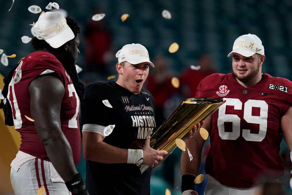 Alabama quarterback Mac Jones, middle, offensive linemen Alex Leatherwood, left, and Landon Dic ...