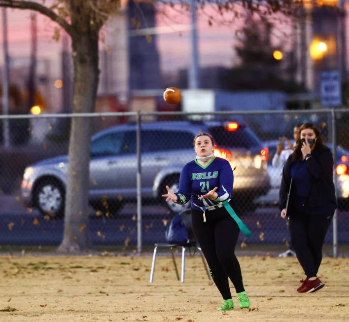 SLAM! Nevada's Sydney Cox (21) catches a pass while playing Amplus Academy during a flag footba ...