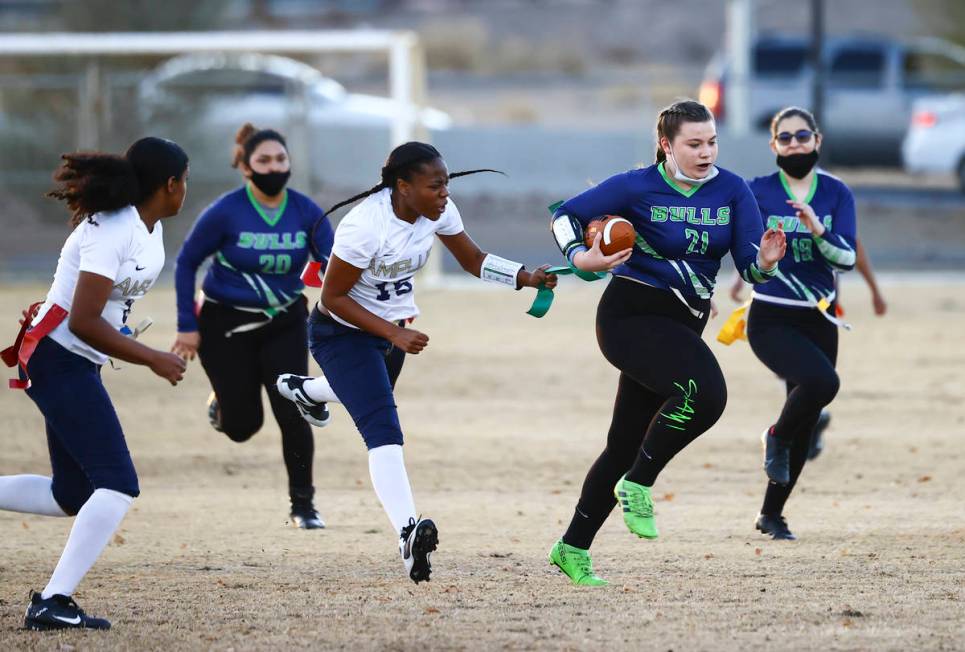 SLAM! Nevada's Sydney Cox (21) gets tagged out by Amplus Academy's Tiani Moore (15) during a fl ...