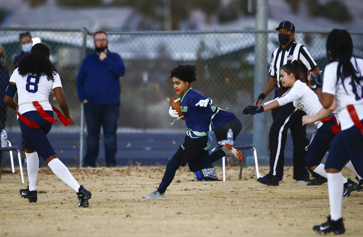 SLAM! Nevada's Iris Cardoza runs the ball against Amplus Academy during a flag football game at ...