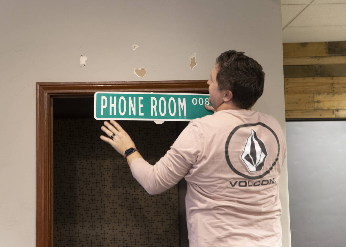 Kenny Eliason, co-owner of Work in Progress, removes signage during the businesses last day on ...