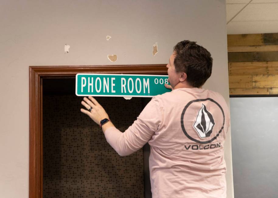 Kenny Eliason, co-owner of Work in Progress, removes signage during the businesses last day on ...