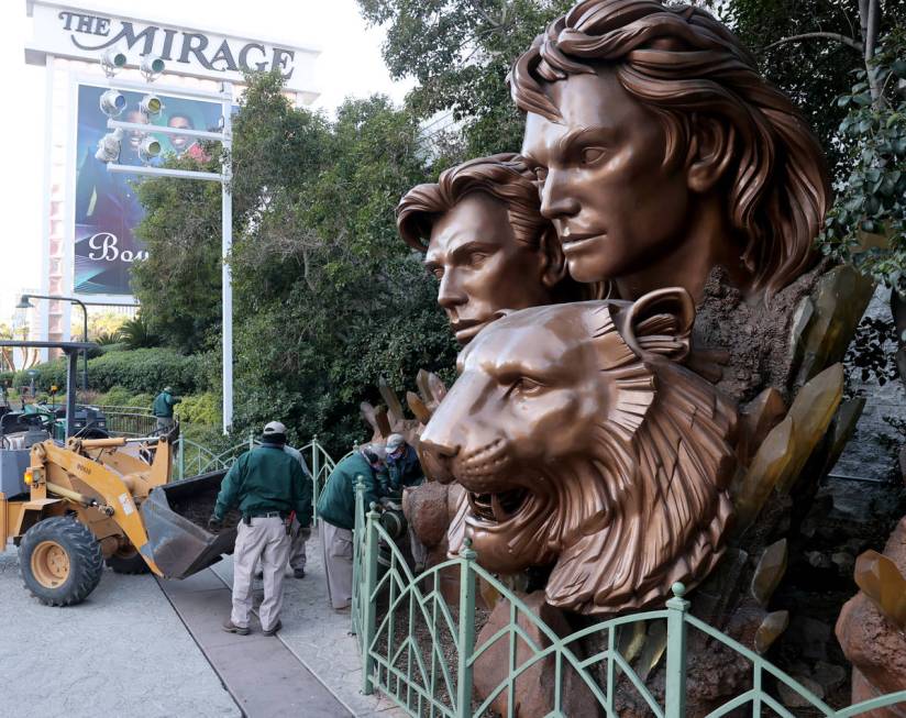 Maintenance employees work on the area around a statue of Siegfried & Roy on the Strip in f ...