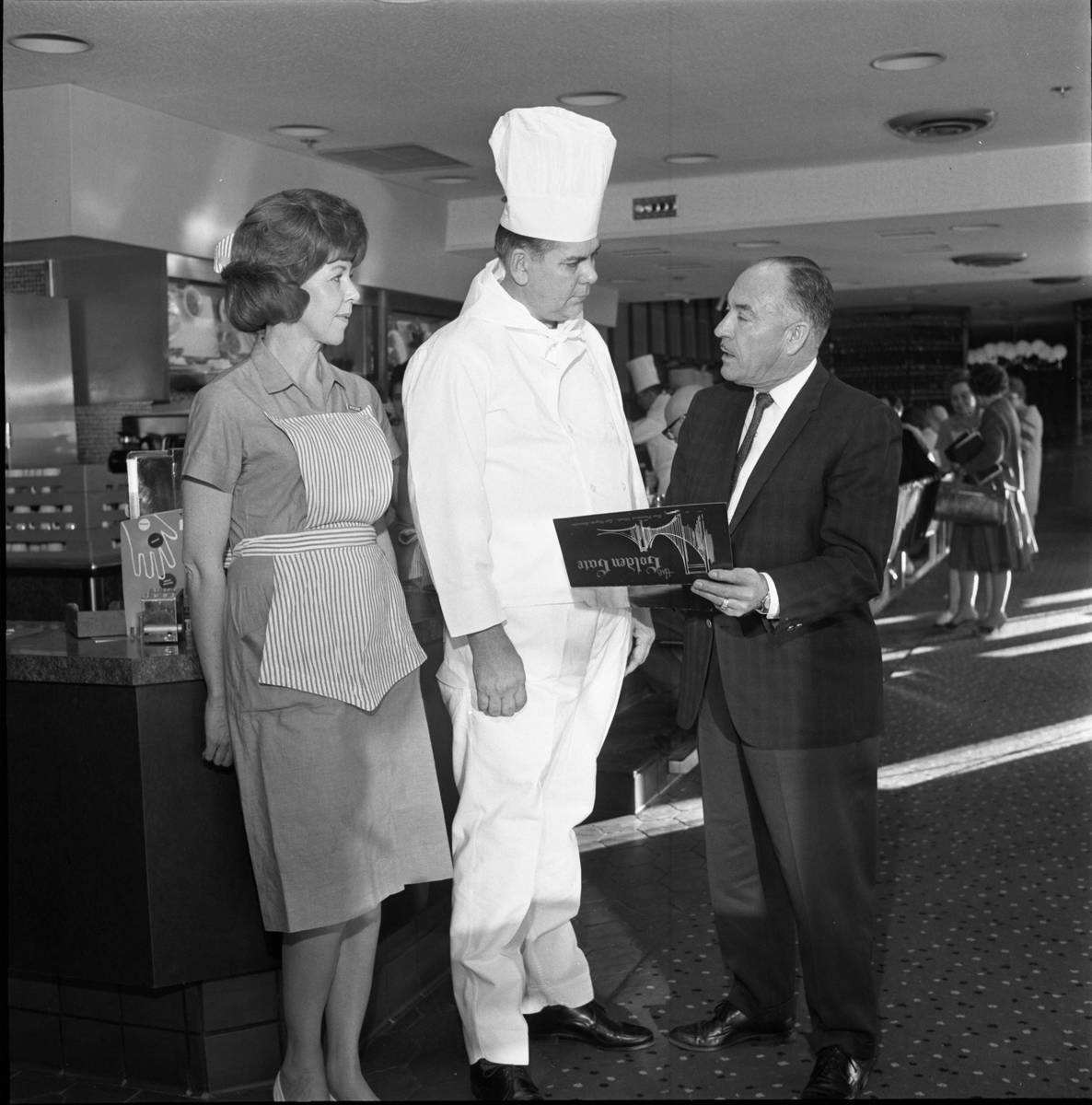 Golden Gate restaurant employees Vivian Murrey, left, Ben Odette and Al Durante hold a menu ins ...
