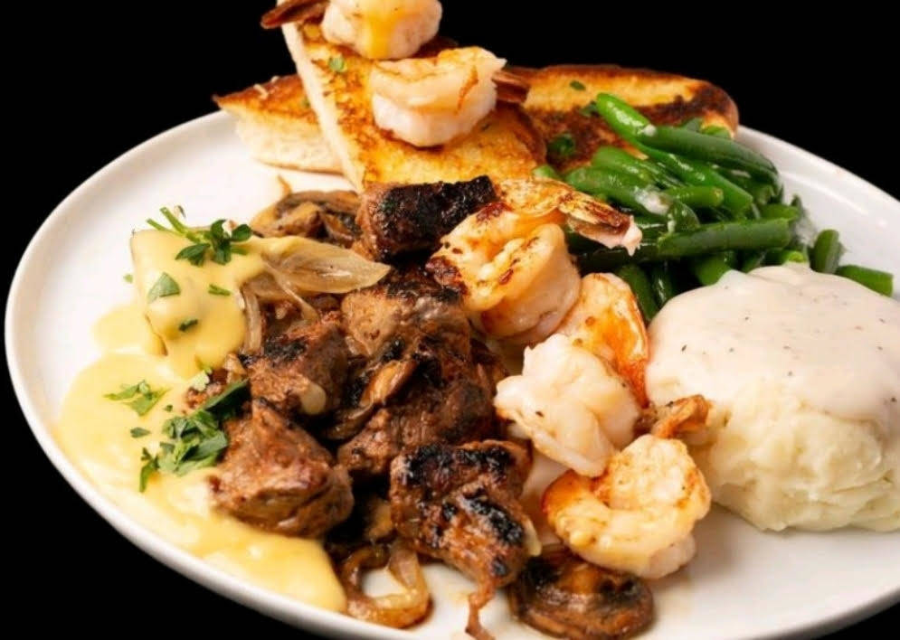 Vegas Surf and Turf includes marinated sirloin tips with grilled onions and mushrooms and grill ...