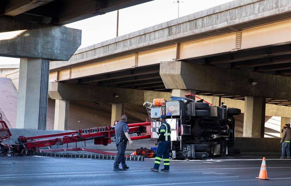 A semi-truck overturned in the eastbound lanes of Sahara Avenue at the I-15 overpass causing tr ...