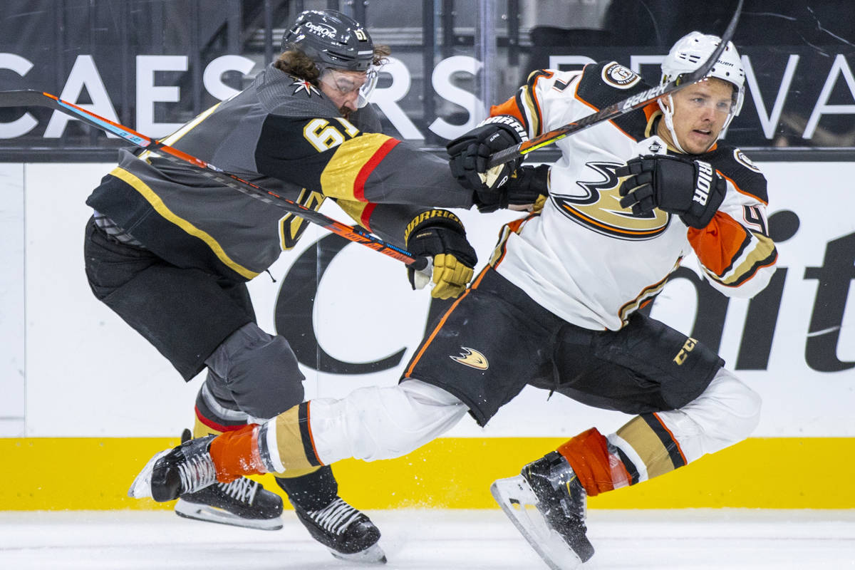 Golden Knights right wing Mark Stone (61) checks Anaheim Ducks defenseman Hampus Lindholm (47) ...