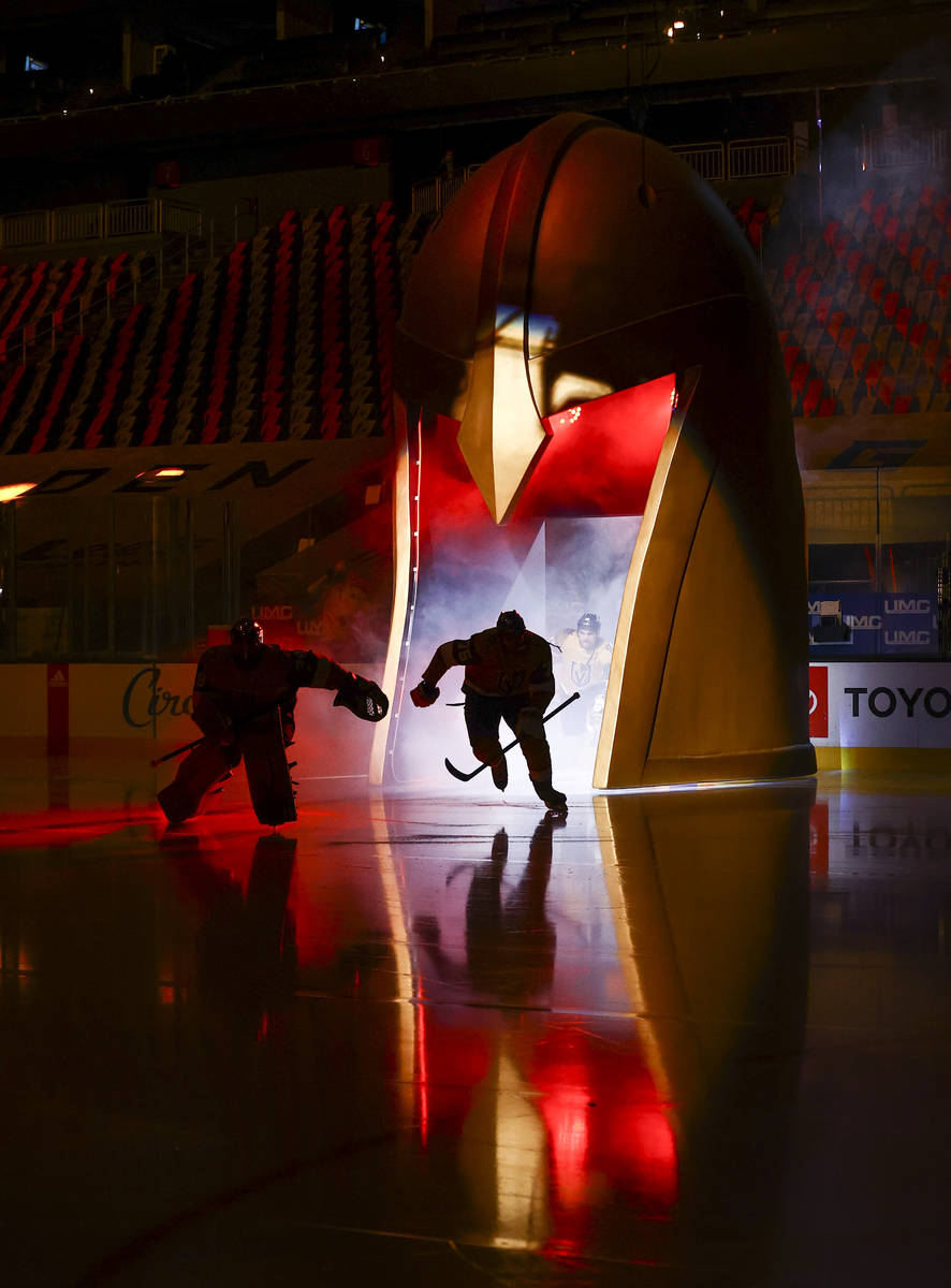 Golden Knights players skate onto the ice before taking on the Anaheim Ducks in an NHL hockey g ...