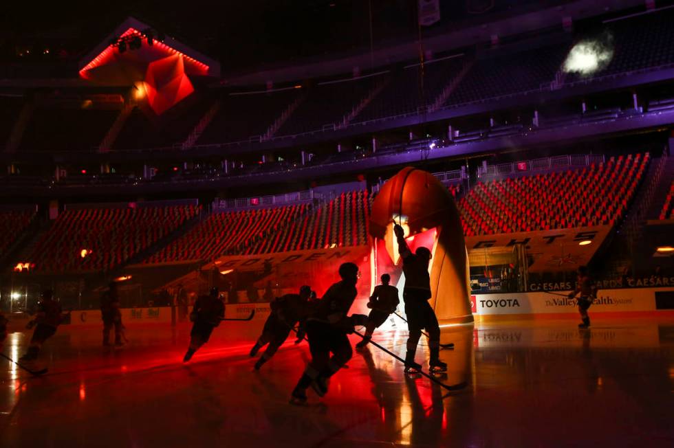 Golden Knights players skate onto the ice before taking on the Anaheim Ducks in an NHL hockey g ...