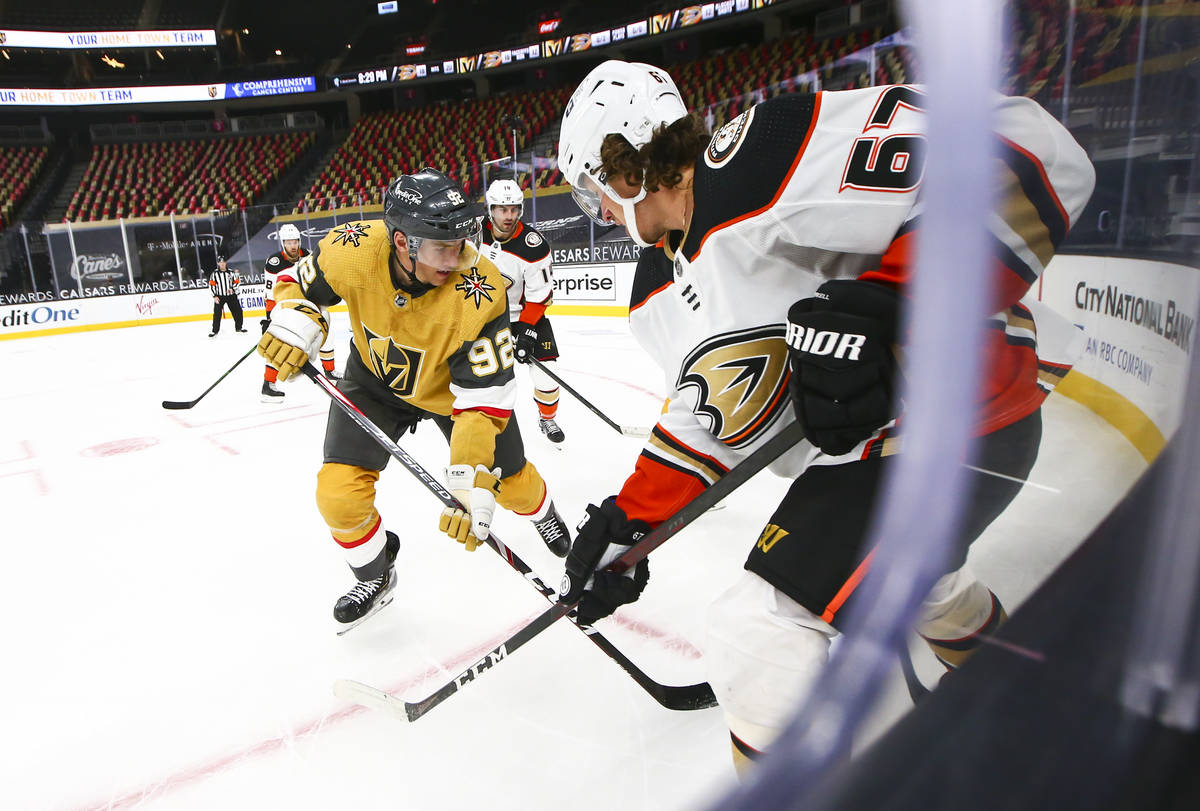 Golden Knights left wing Tomas Nosek (92) and Anaheim Ducks center Rickard Rakell (67) battle f ...