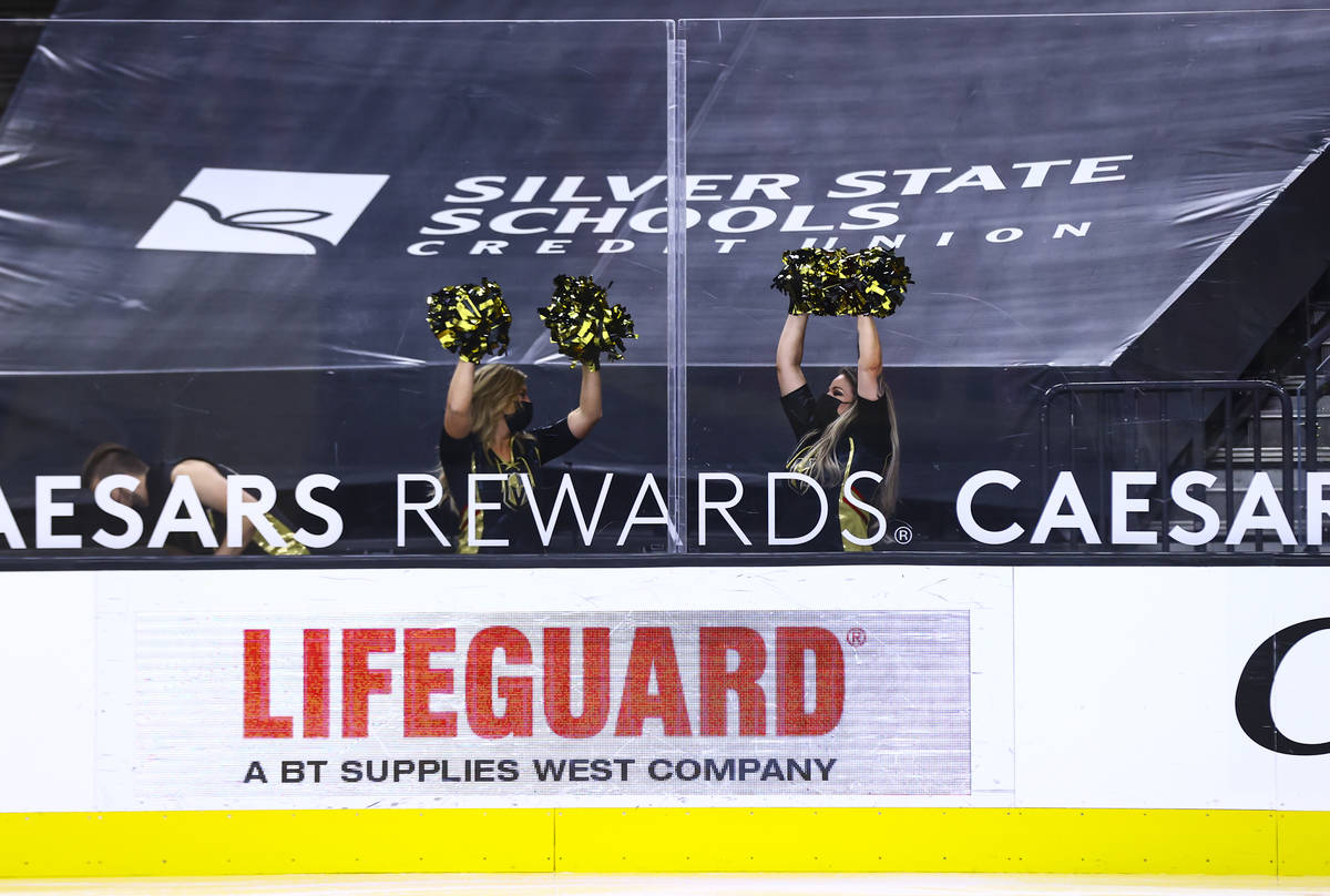 Members of the Knights Guard ice crew cheer during the third period of an NHL hockey game betwe ...