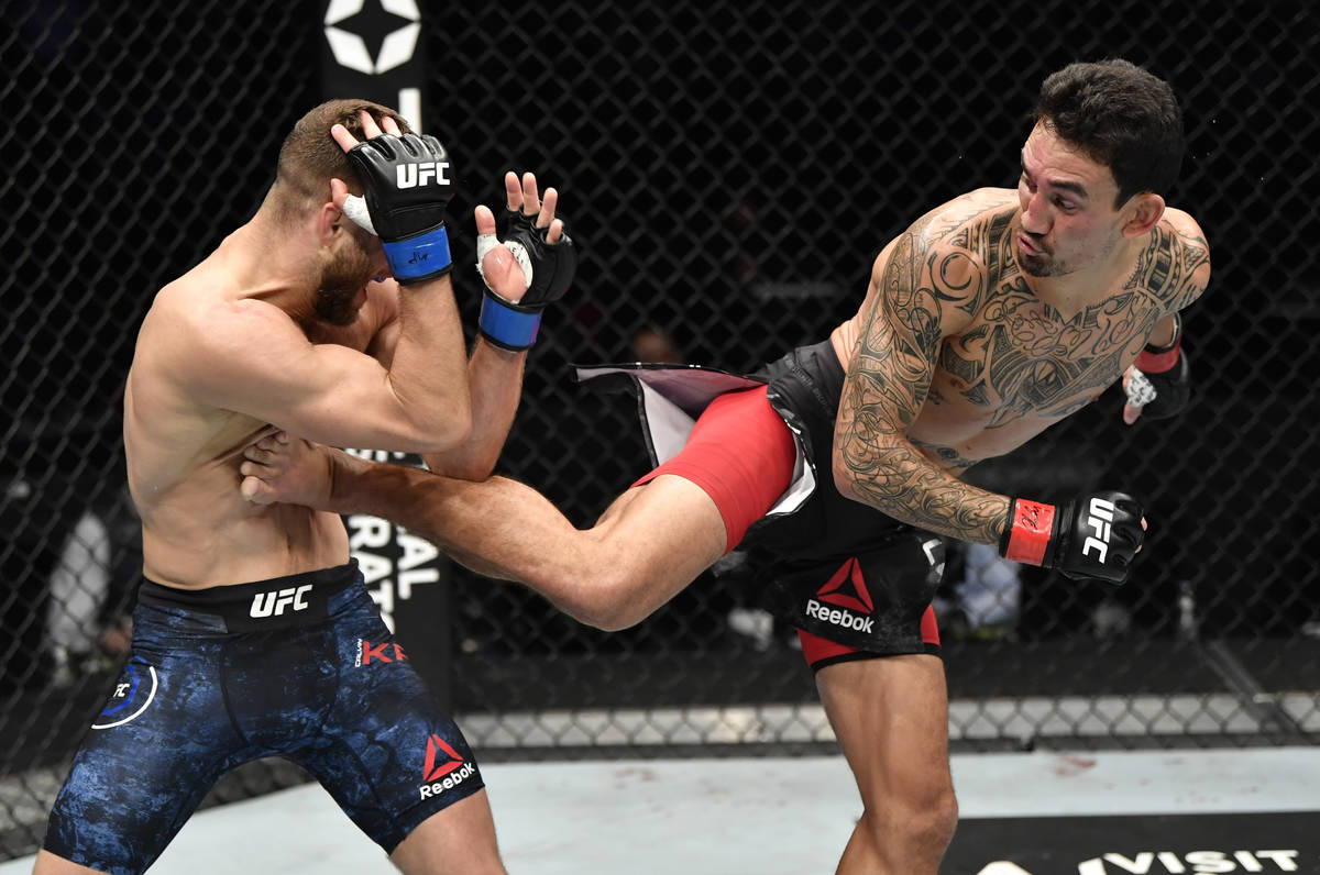 (R-L) Max Holloway kicks Calvin Kattar in a featherweight bout during the UFC Fight Night event ...