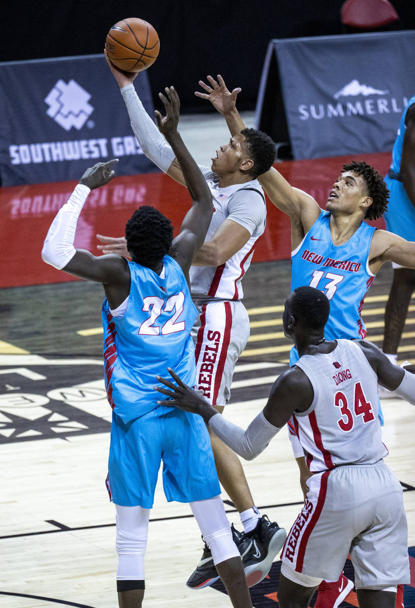 UNLV Rebels guard Nicquel Blake (22) elevates for a shot past New Mexico Lobos forward Valdir M ...